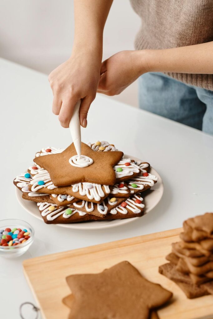 A Person Putting Whipped Cream on Top of the Cookies