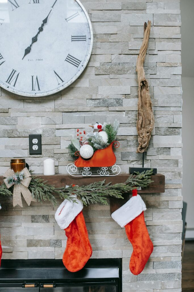 Clock on wall above Christmas decor during festive event
